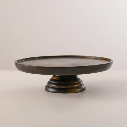 WOOD CURLS round mango wood cake stand with a rich walnut finish and sturdy pedestal base for dessert display.