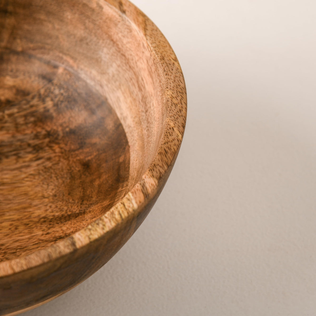 WOOD CURLS 10-inch mango wood serving bowl with natural grain detail, perfect for salads, fruits, or table decor.