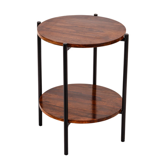 WOOD CURLS Serenity round coffee table in natural Sheesham wood with two tiers and sleek black metal legs.