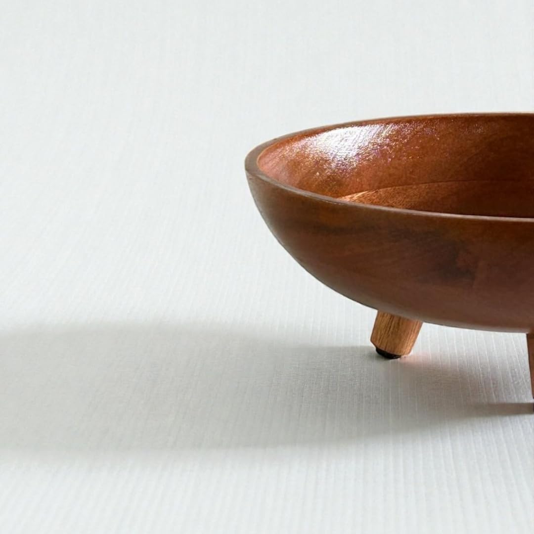 Wooden bowl with three legs on a white background
