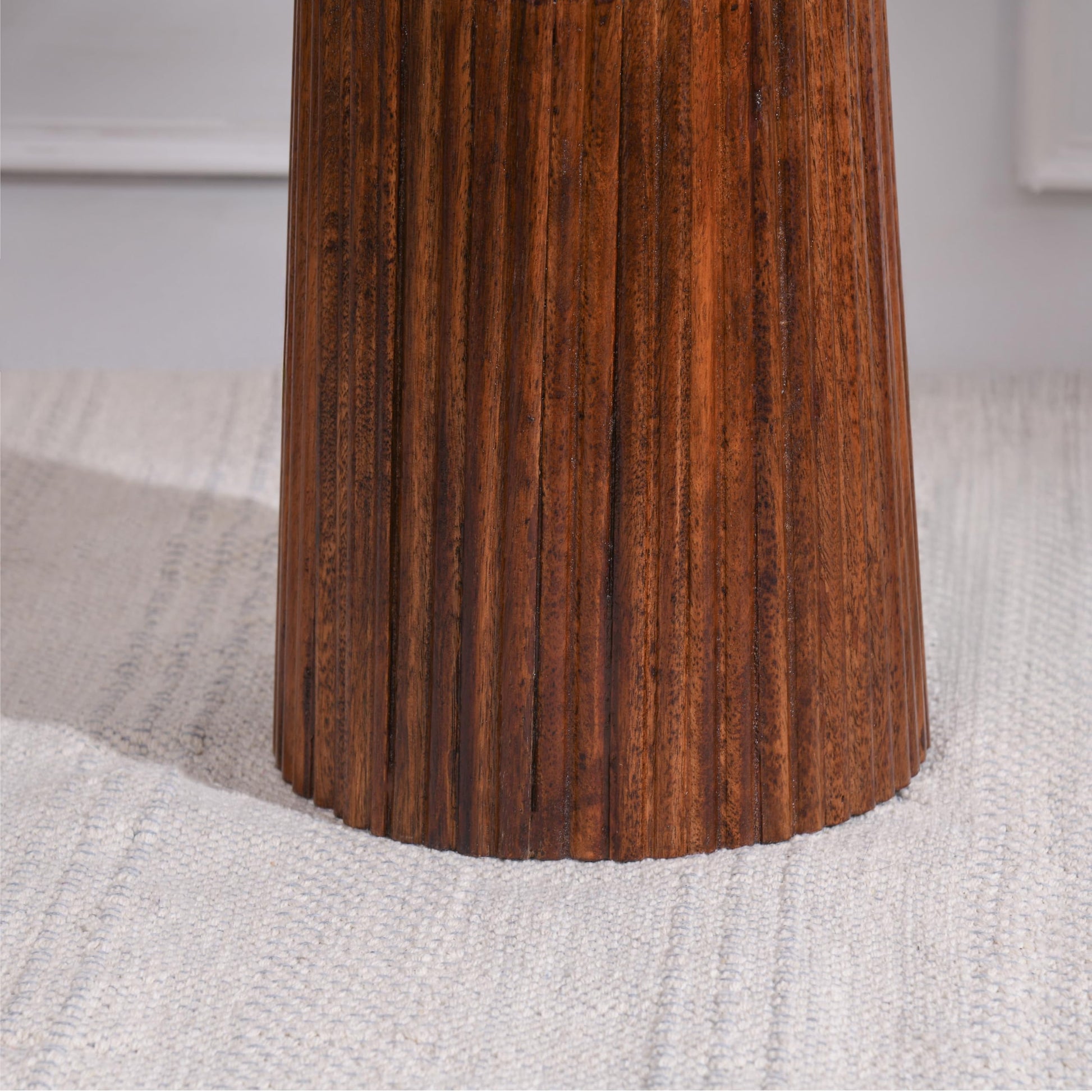 Close-up of a wooden leg on a textured surface