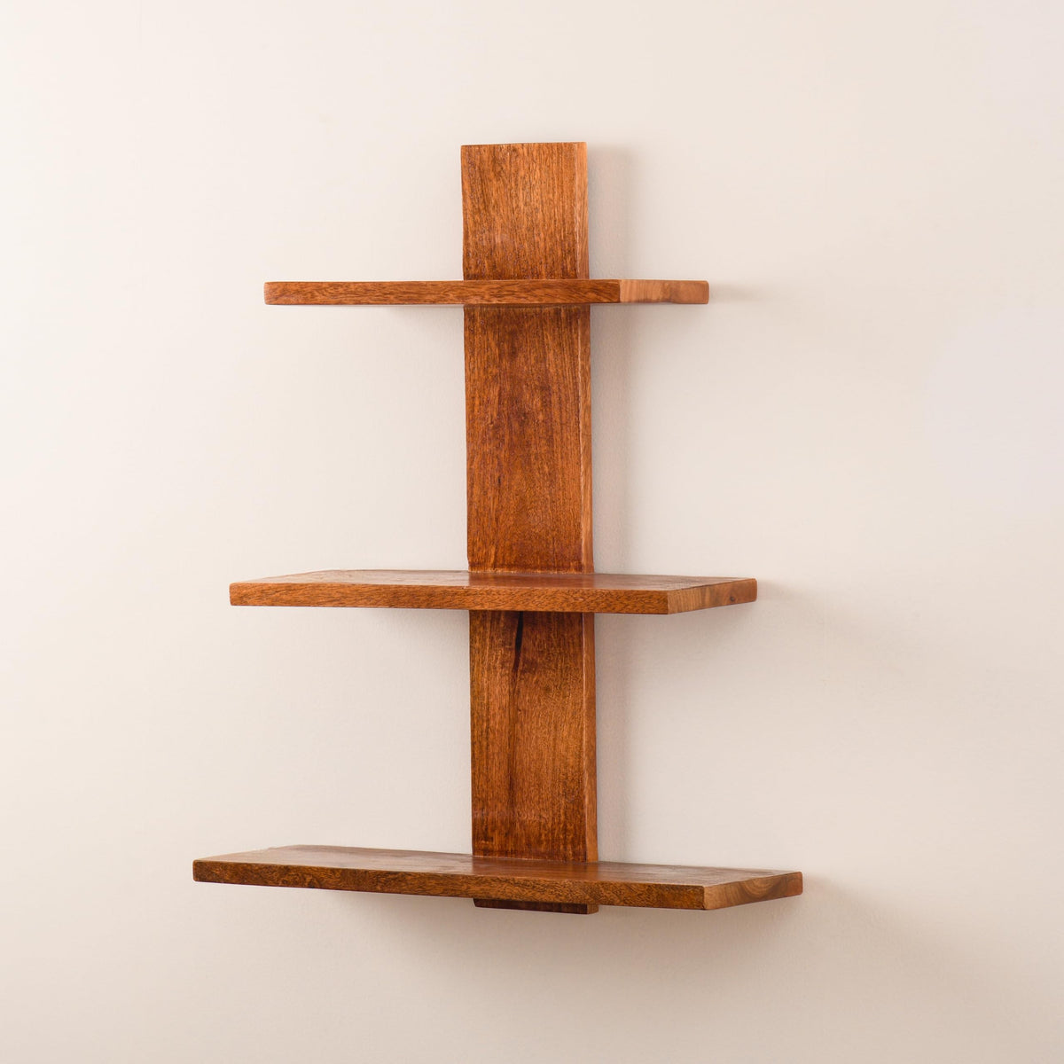 WOOD CURLS 3-tier wall-mounted shelf made of natural brown mango wood with visible grain patterns.