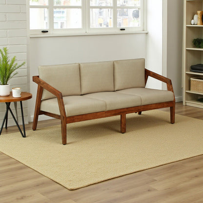WOOD CURLS Arden 3-seater sofa with a solid acacia wood frame and plush beige fabric cushions in a bright living room