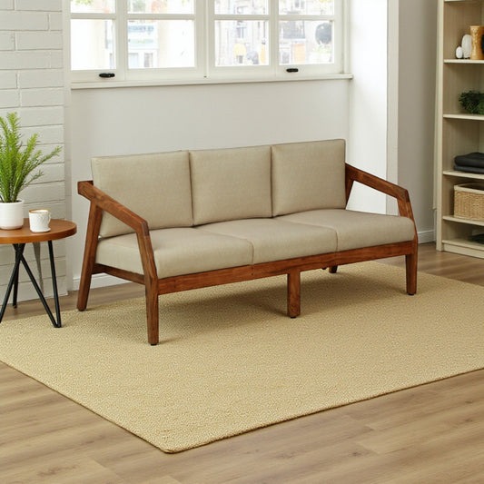 WOOD CURLS Arden 3-seater sofa with a solid acacia wood frame and plush beige fabric cushions in a bright living room