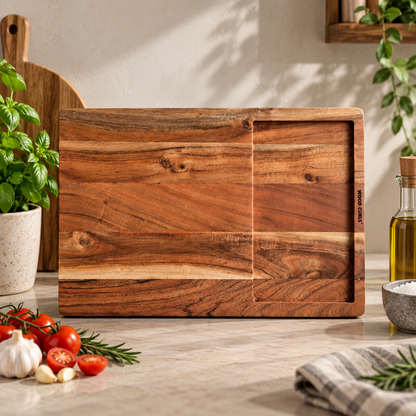 WOOD CURLS rectangular acacia wood cutting board with integrated juice groove on a marble kitchen countertop