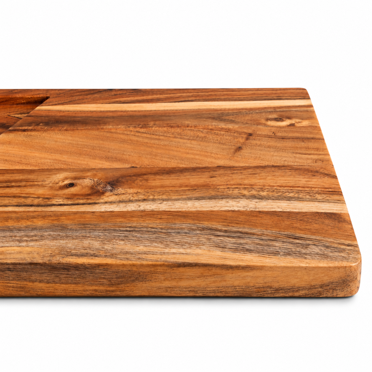 WOOD CURLS rectangular acacia wood cutting board with natural grain and integrated juice groove on white background