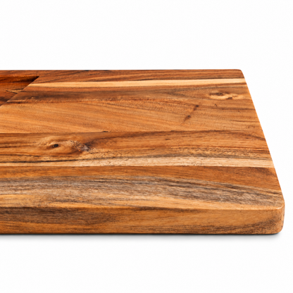 WOOD CURLS rectangular acacia wood cutting board with natural grain and integrated juice groove on white background