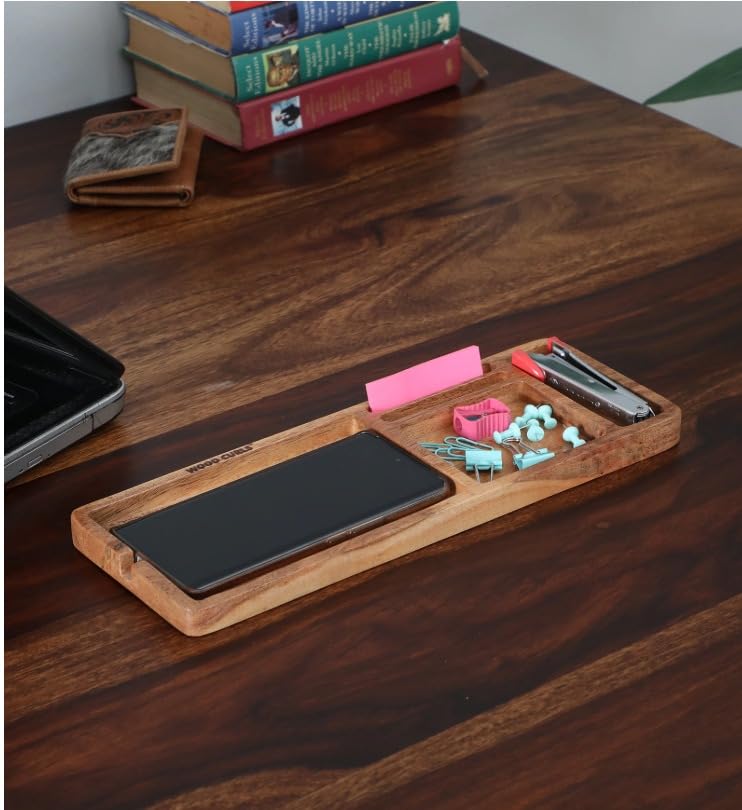 WOOD CURLS acacia wood desk organizer tray with compartments holding a smartphone, stationery, and office supplies.