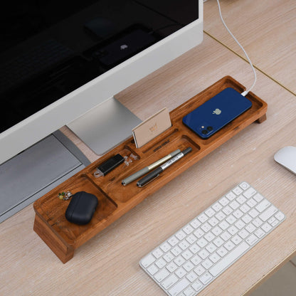 WOOD CURLS handcrafted acacia wood desk organizer with multiple compartments holding stationery and gadgets on a desk.