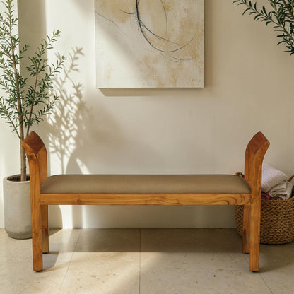 WOOD CURLS Thalia dining bench in solid acacia wood with a brown upholstered seat and elegant curved backrests.
