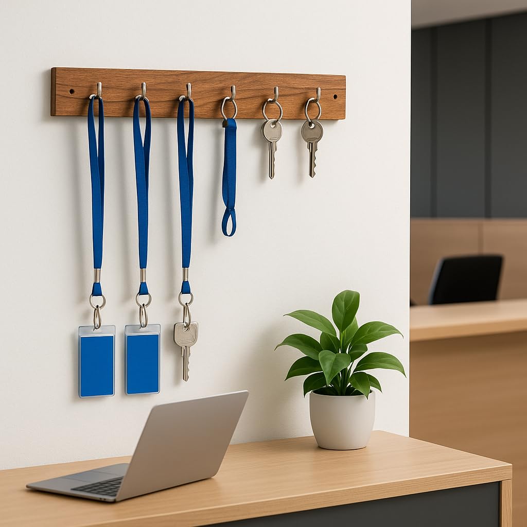 WOOD CURLS wall-mount key holder made of natural acacia wood with 5 metal hooks holding keys and blue lanyards.