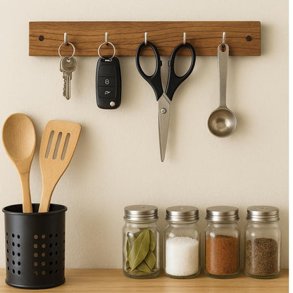 WOOD CURLS wall-mount acacia wood key holder with 5 silver hooks holding keys and kitchen tools above spice jars