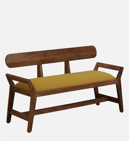 WOOD CURLS Alderra mango wood bench with a mustard velvet seat, backrest, and tapered legs in a mid-century style.
