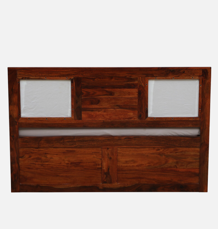WOOD CURLS Arbor queen size bed headboard in solid Sheesham wood with a honey oak finish and upholstered panels.