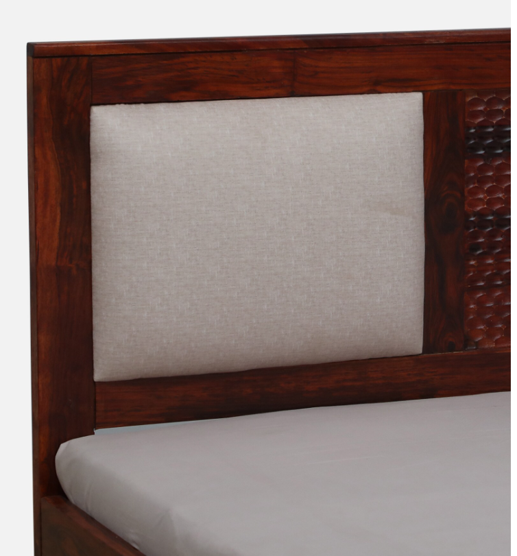 WOOD CURLS Arbor queen bed featuring a honey oak solid sheesham wood frame and a beige upholstered headboard.