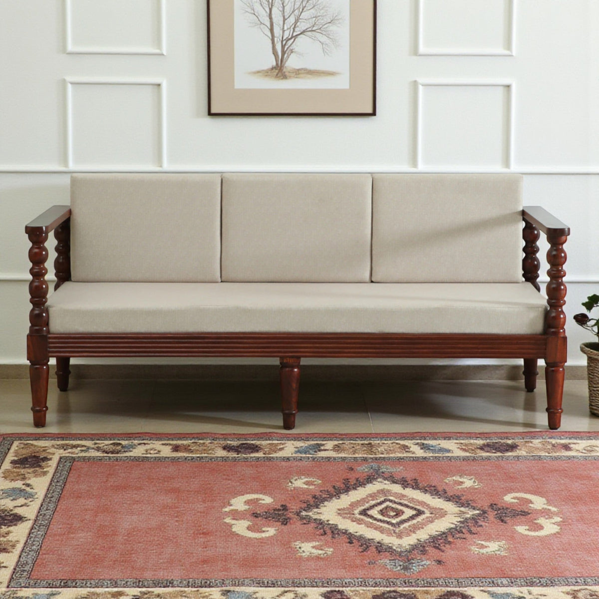 WOOD CURLS Auburn three seater sofa in beige upholstery with a solid Sheesham wood frame and elegant carved armrests.
