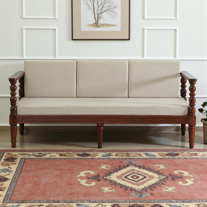 WOOD CURLS Auburn three seater sofa in beige upholstery with a solid Sheesham wood frame and elegant carved armrests.