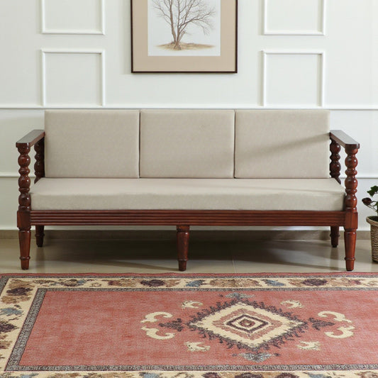 WOOD CURLS Auburn three seater sofa in beige upholstery with a solid Sheesham wood frame and elegant carved armrests.