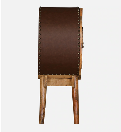 WOOD CURLS Ayra round mango wood cabinet side view featuring a brown leatherette back panel with antique metal studs.