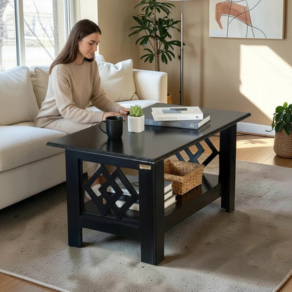 WOOD CURLS modern black wooden coffee table with geometric side panels and lower storage shelf in a living room