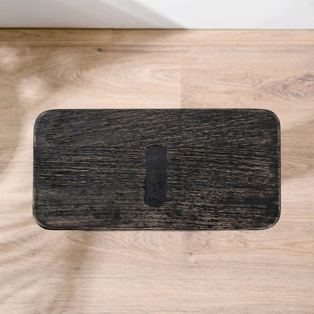 WOOD CURLS black mango wood side table top view showing the rectangular surface and natural wood grain texture.