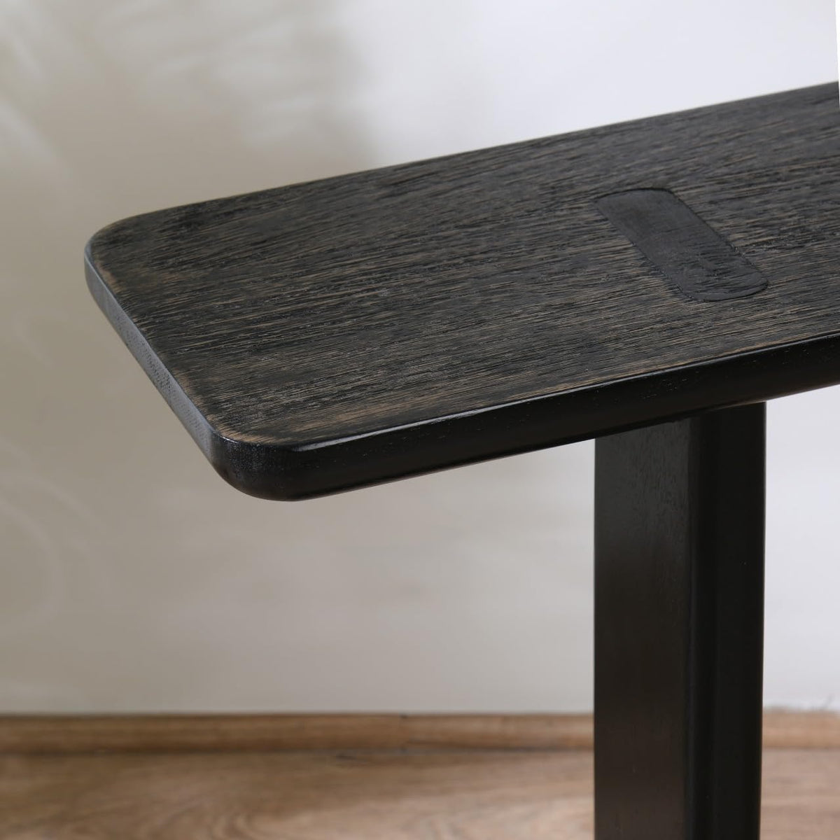 WOOD CURLS modern black mango wood side table with a sleek C-frame design and visible wood grain texture