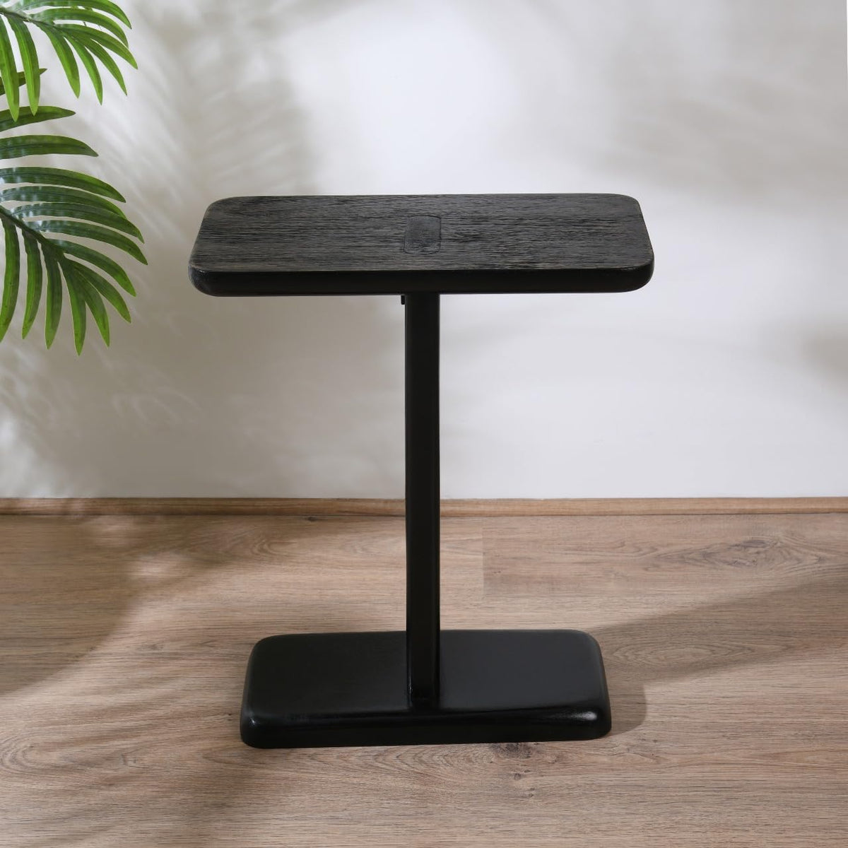 WOOD CURLS modern black mango wood C-frame side table with a rectangular top and sturdy pedestal base.