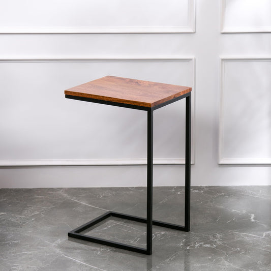 WOOD CURLS Odyssey C-shape side table with a warm mango wood top and a durable black iron frame on a marble floor.