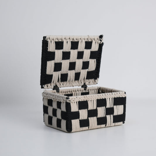 WOOD CURLS handwoven cotton rope storage box with a black and beige checkered pattern and an open hinged lid.