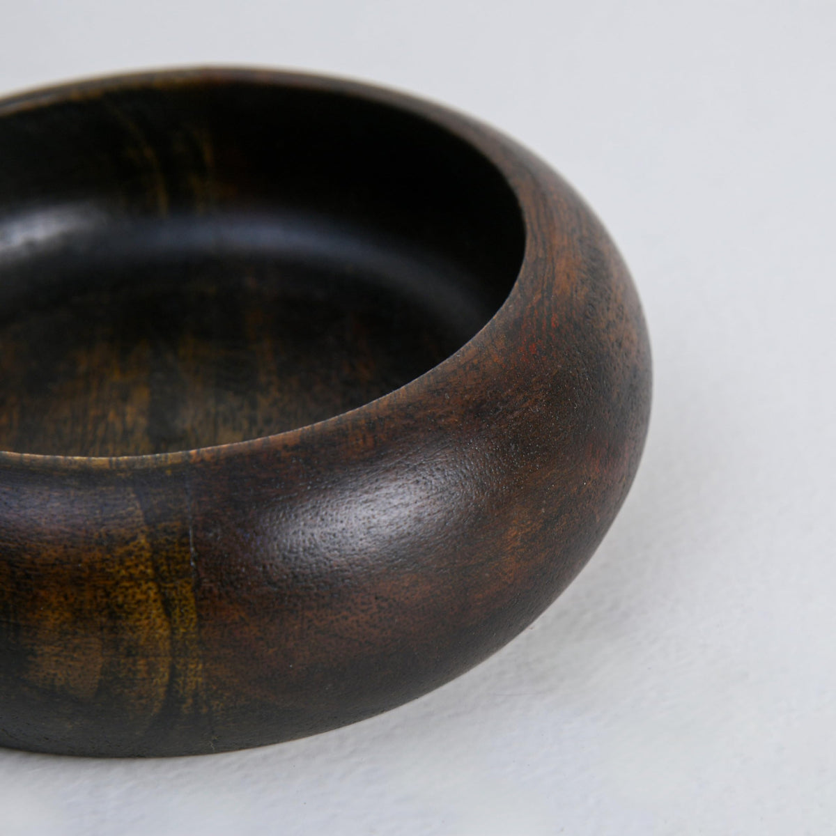 WOOD CURLS handcrafted dark brown wooden ashtray with a deep bowl design and visible natural wood grain patterns.
