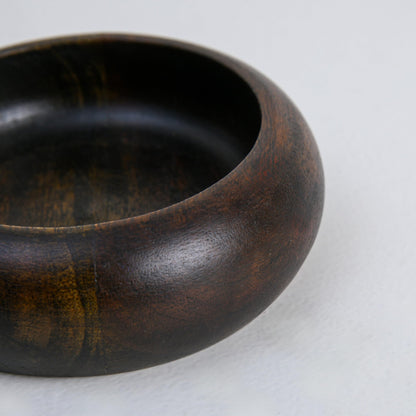 WOOD CURLS handcrafted dark brown wooden ashtray with a deep bowl design and visible natural wood grain patterns.