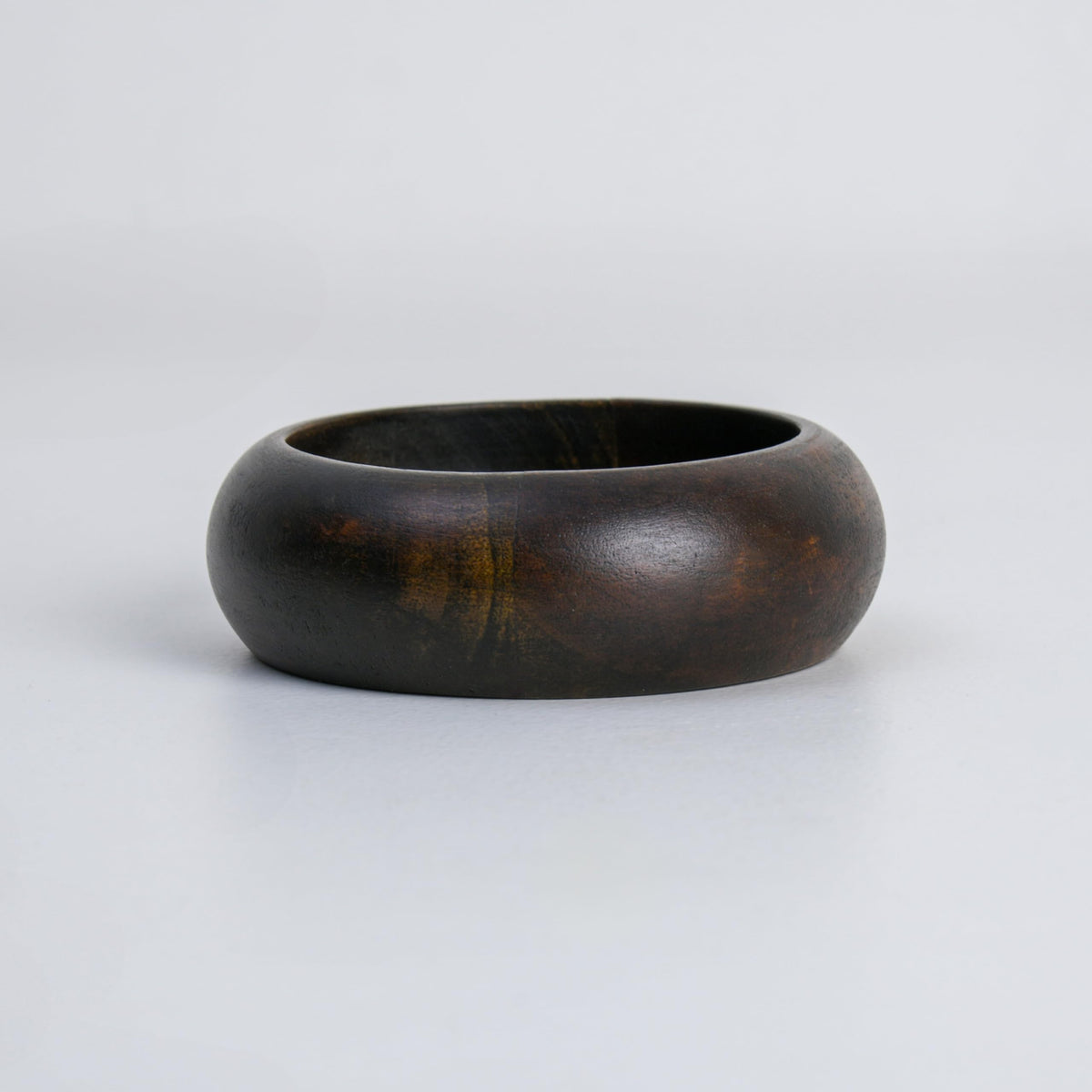 WOOD CURLS handcrafted dark brown wooden ashtray with a smooth, deep bowl design and unique natural wood grain.