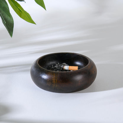 WOOD CURLS handcrafted dark brown wooden ashtray with a deep bowl design and a cigarette resting inside