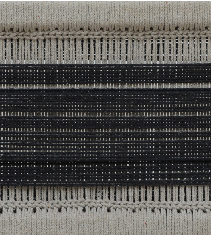 Close-up of WOOD CURLS Eira bench seat featuring hand-woven monochrome cotton rope in black and beige stripes