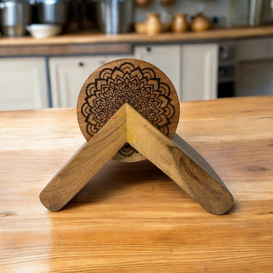 WOOD CURLS handcrafted round mango wood tea coasters with intricate floral engraving and a matching wooden stand.