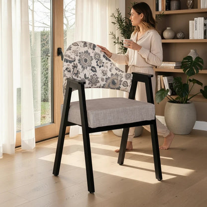 WOOD CURLS Florence arm chair with black Sheesham wood frame, floral print backrest, and grey cushioned seat