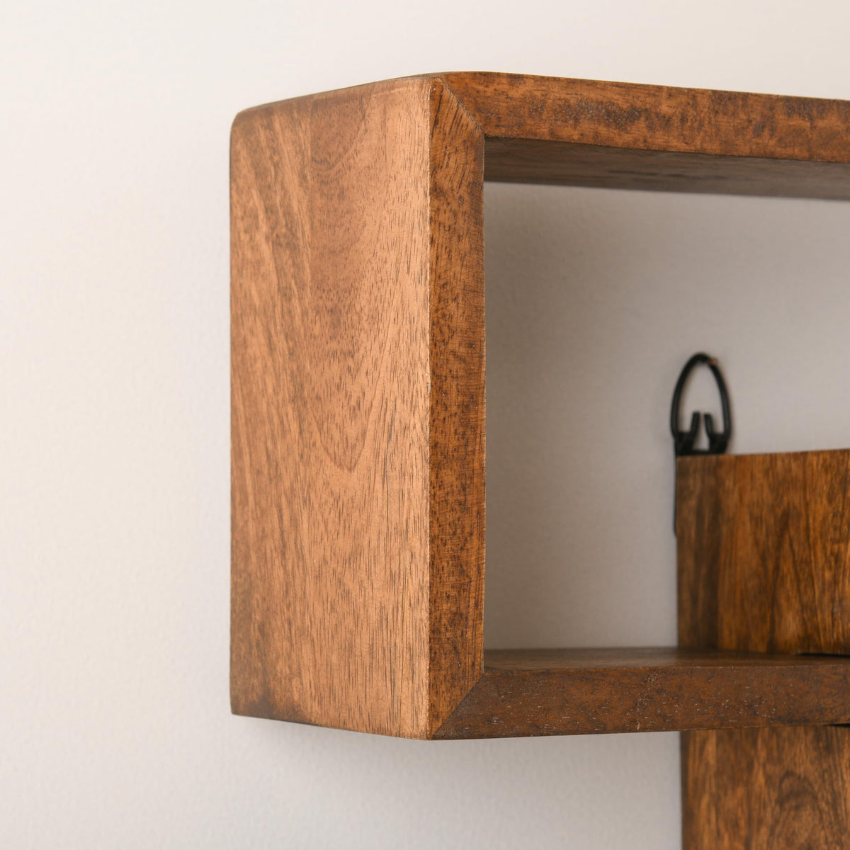 WOOD CURLS geometric wall shelf made of solid brown mango wood with a smooth finish and visible grain detail