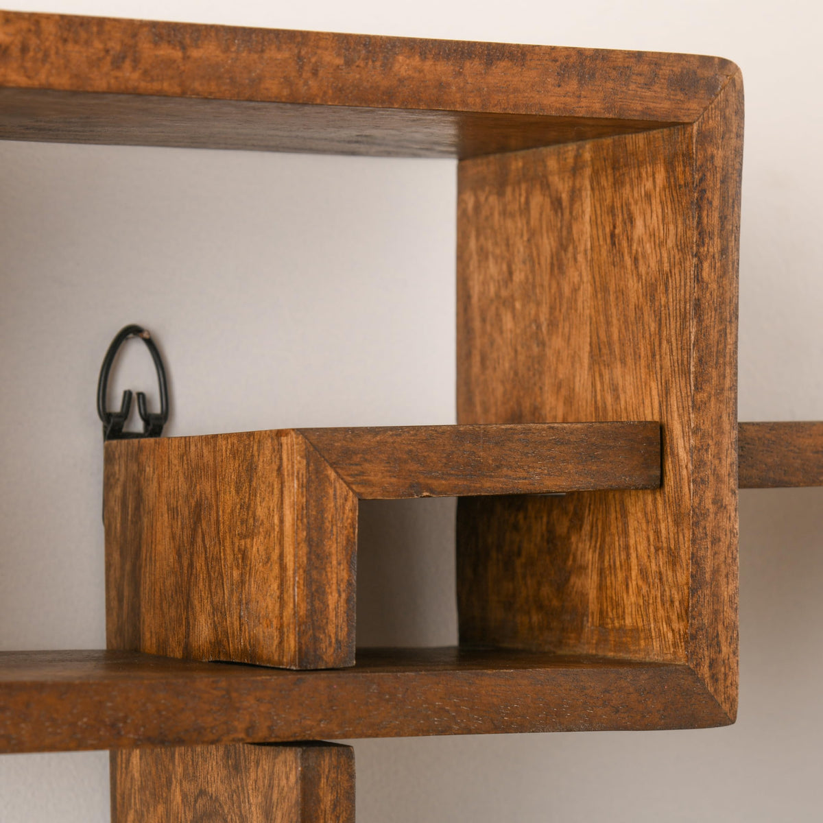 WOOD CURLS geometric intersecting wall shelf crafted from solid brown mango wood with a natural grain finish
