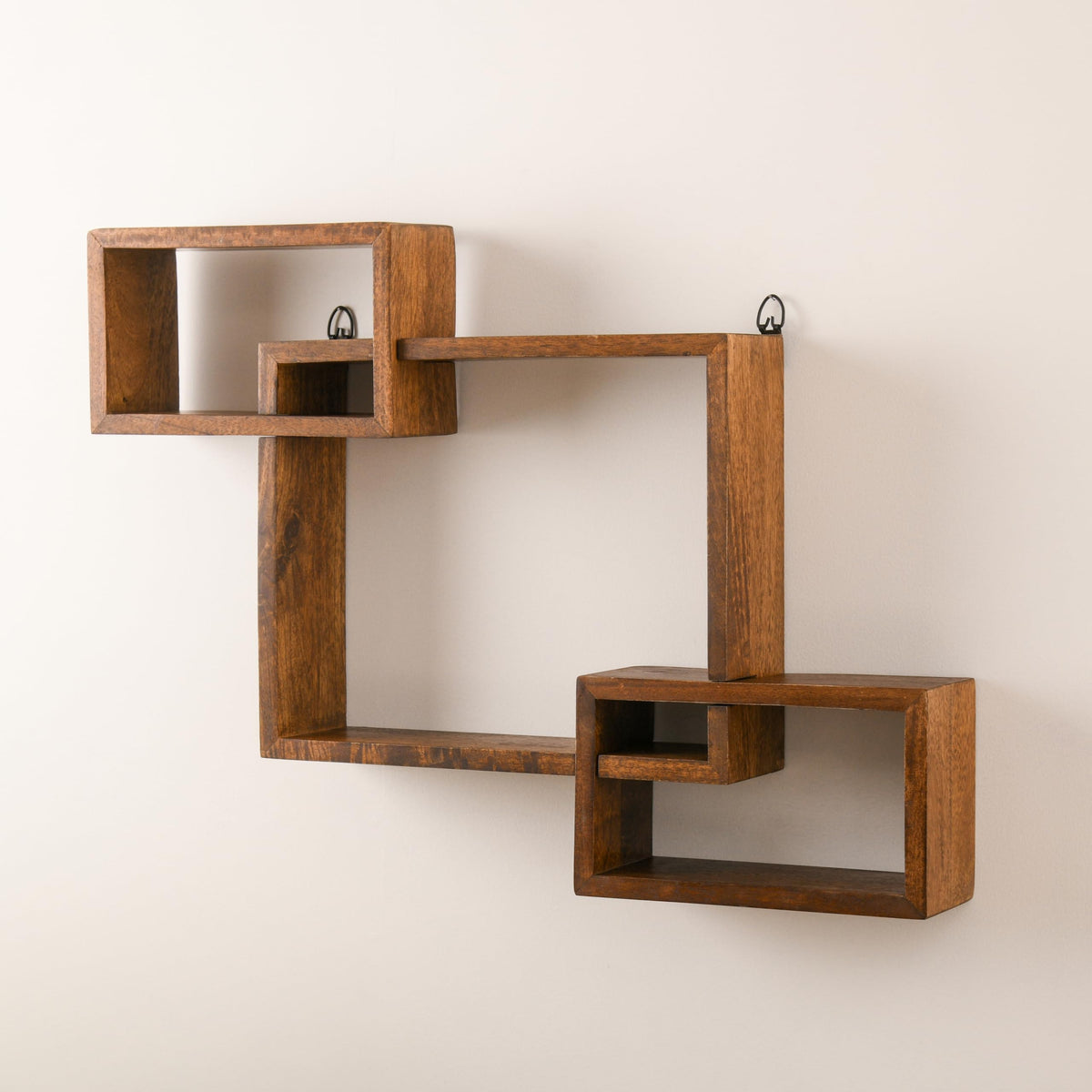 WOOD CURLS geometric intersecting wall shelf made of solid brown mango wood for modern home decor display