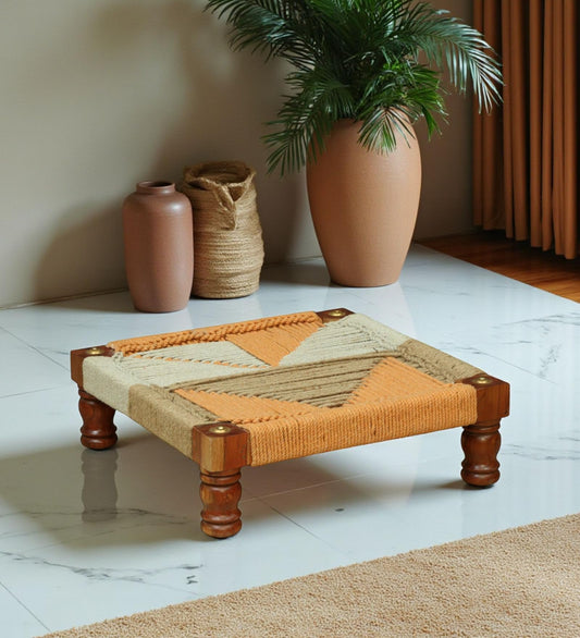 WOOD CURLS handwoven wooden chowki with geometric rope pattern in natural and peach tones on a marble floor