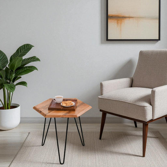 WOOD CURLS hexagon side table made of solid mango wood with black iron hairpin legs in a modern living room setting.