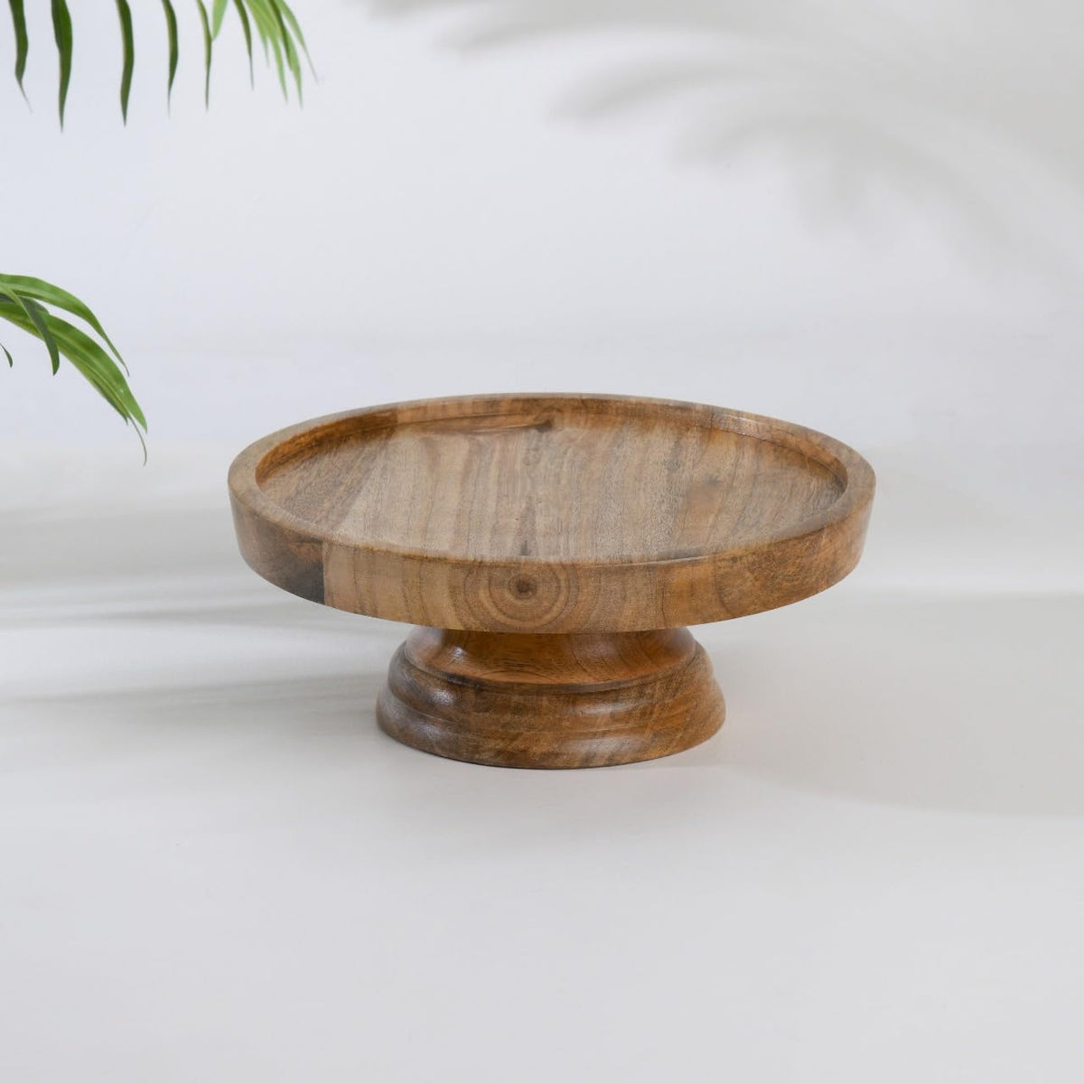 WOOD CURLS round mango wood pedestal cake stand with a natural grain finish for dessert display and table decor.