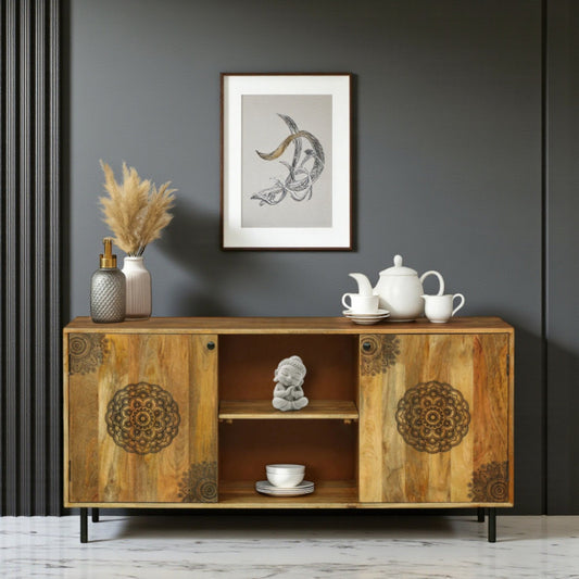WOOD CURLS handcrafted mango wood cabinet with intricate mandala carvings on doors against a dark grey wall.