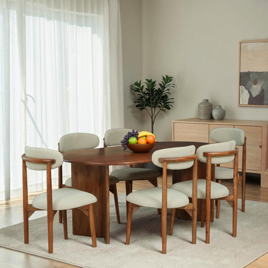 WOOD CURLS Arcadia solid mango wood oval dining table set with six ergonomic upholstered chairs in a modern room