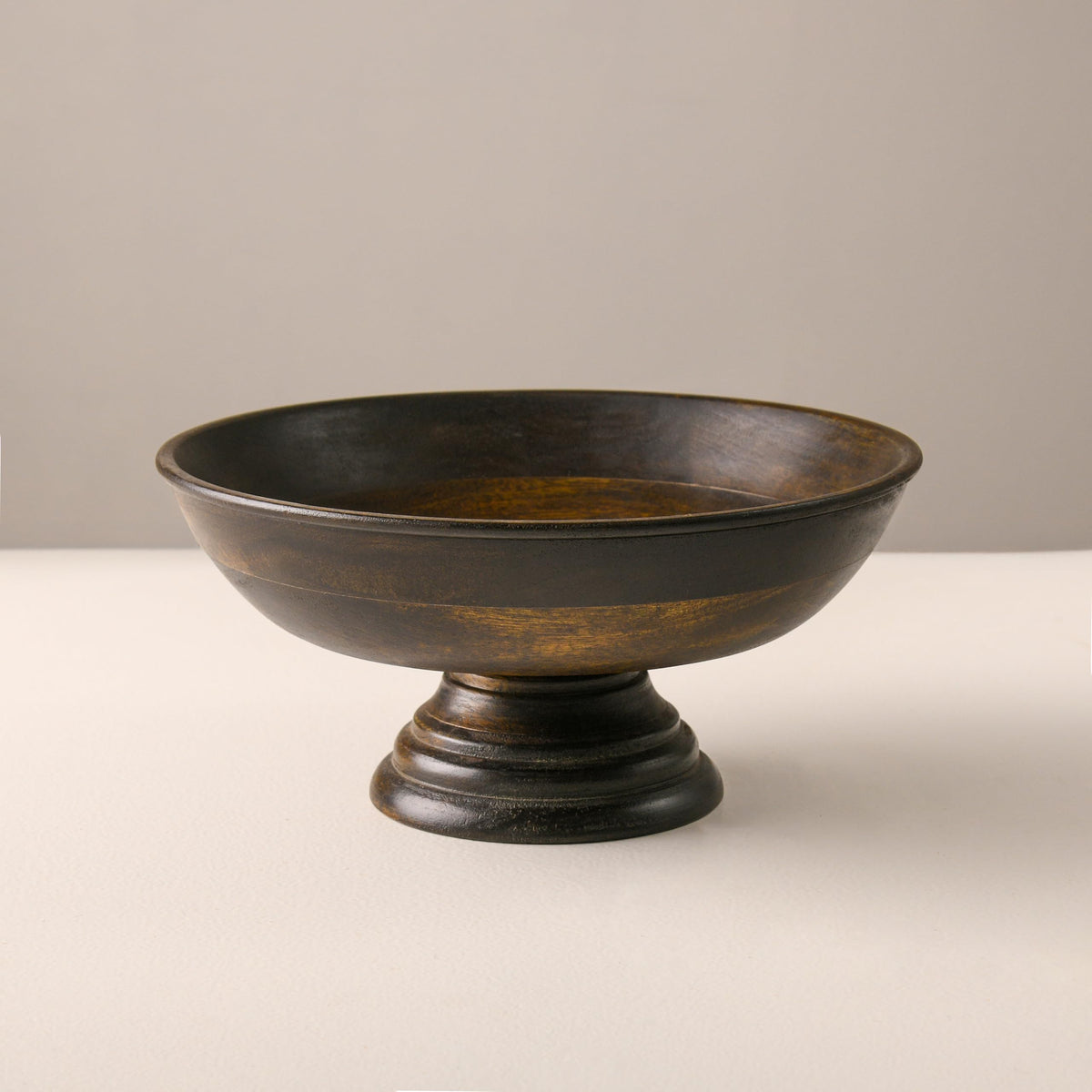 WOOD CURLS handcrafted mango wood pedestal bowl with a natural walnut finish, perfect for fruit or table decor.