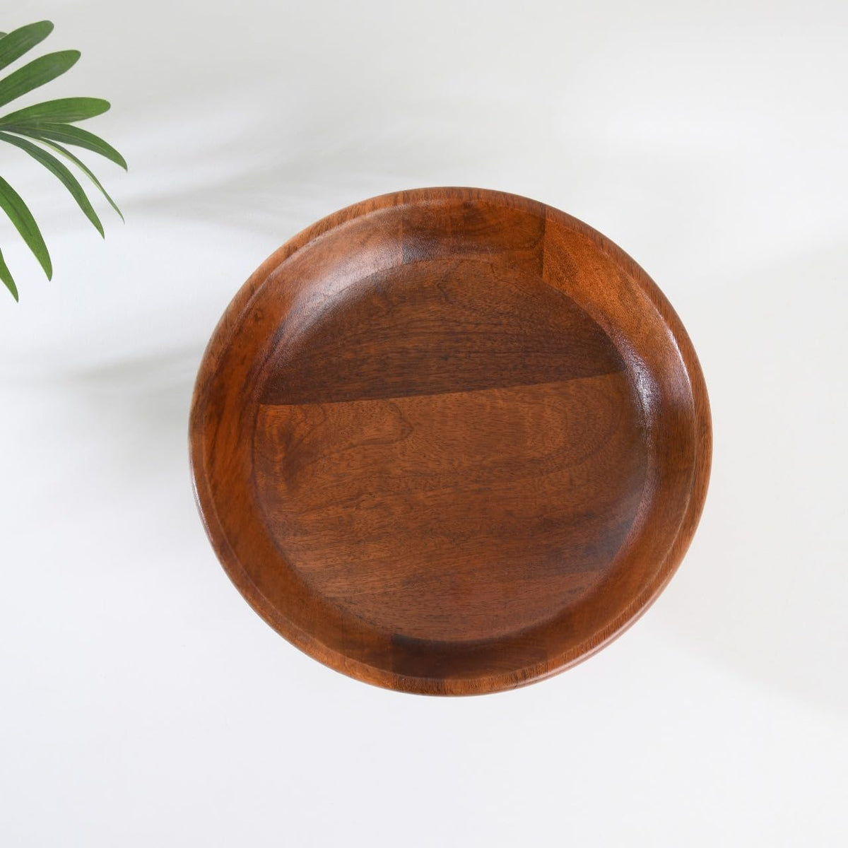 WOOD CURLS handcrafted mango wood pedestal bowl with natural grain, viewed from above on a white background.
