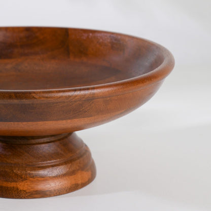 WOOD CURLS handcrafted mango wood pedestal fruit bowl with a smooth natural grain finish on a white background.