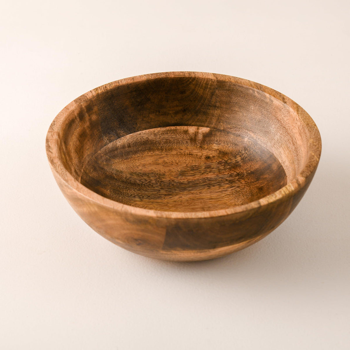 WOOD CURLS 10-inch round mango wood serving bowl with natural grain patterns, perfect for salads or fruit.