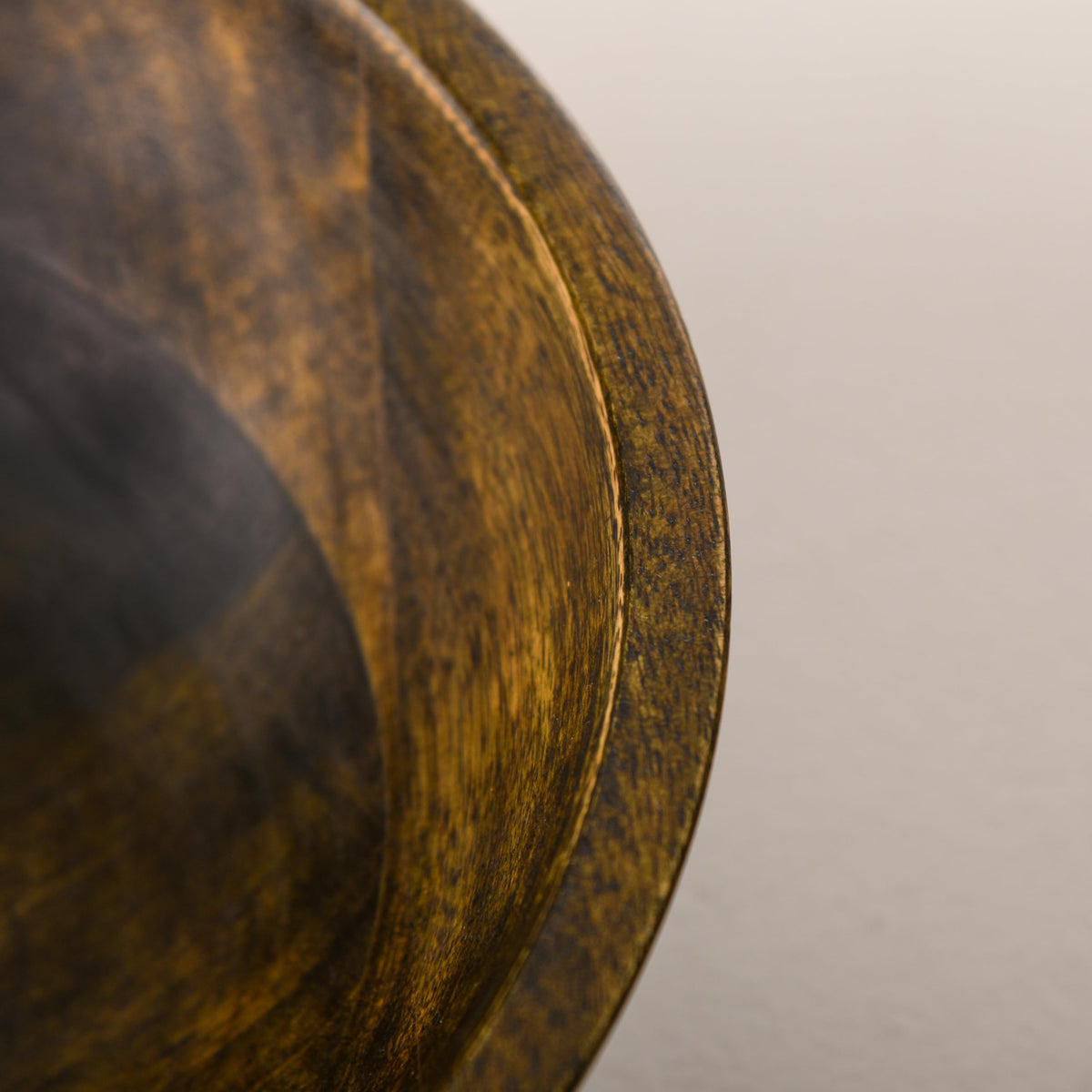 WOOD CURLS 10-inch round mango wood serving bowl with a rich walnut finish and visible natural wood grain texture.