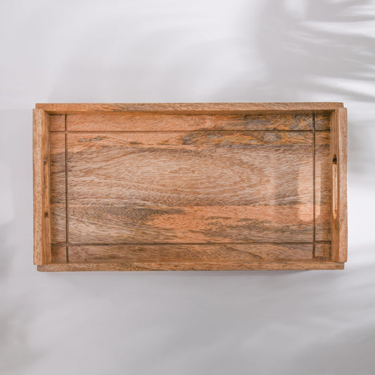WOOD CURLS rectangular serving tray made of natural solid mango wood with side handles and rustic grain patterns.